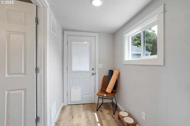 entryway featuring light wood finished floors and baseboards
