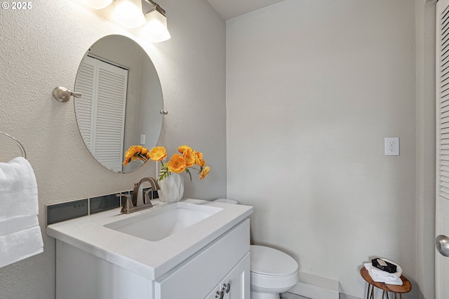 bathroom featuring vanity and toilet