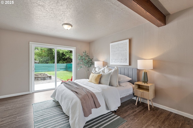 bedroom with access to exterior, wood finished floors, baseboards, and a textured ceiling