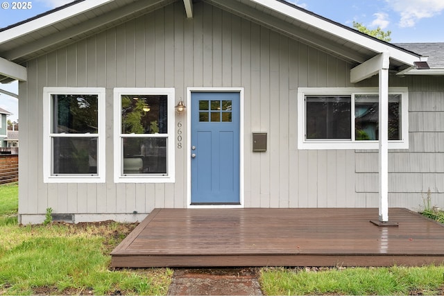 view of exterior entry featuring a deck