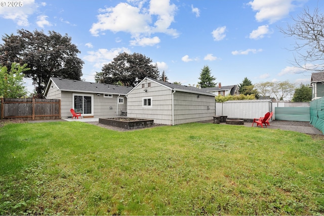 rear view of house featuring an outdoor fire pit, an outdoor structure, and a patio area