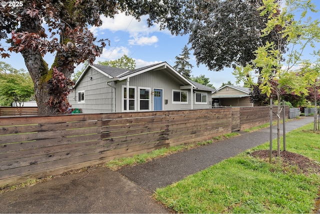 view of front of property featuring fence
