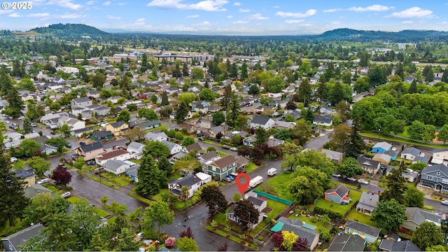 aerial overview of property's location with a mountain backdrop and nearby suburban area