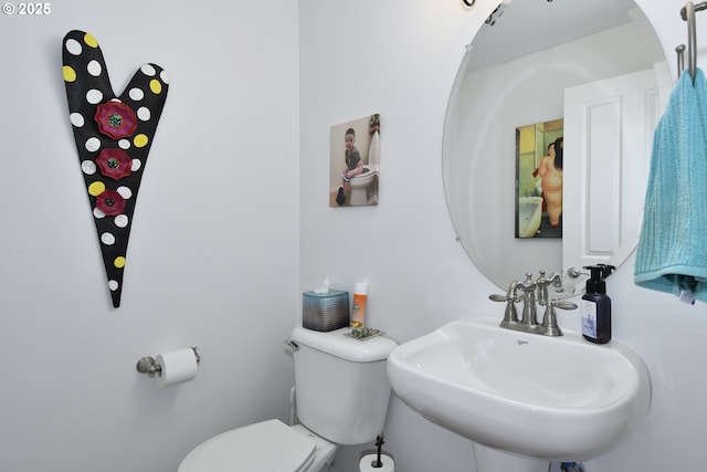 half bathroom with a sink and toilet