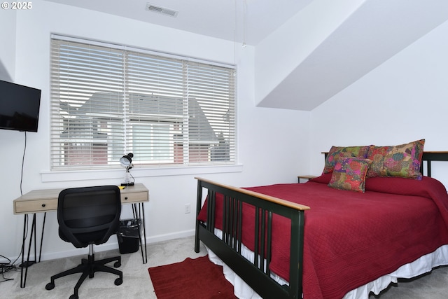 carpeted bedroom featuring visible vents, baseboards, and multiple windows