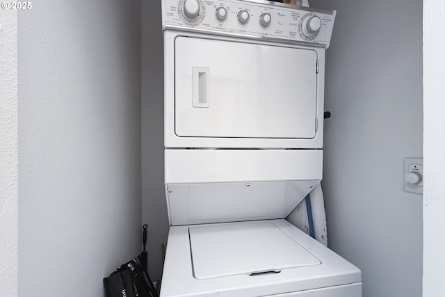 washroom featuring laundry area and stacked washer and dryer