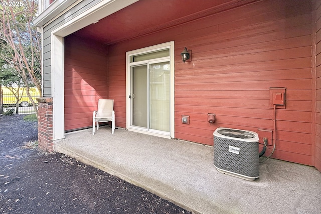 view of patio / terrace featuring fence and central AC unit