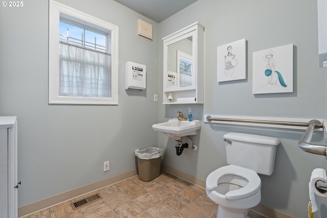 818 NE Division St, Gresham, OR 97030 - half bath with a sink, visible vents, baseboards, and toilet