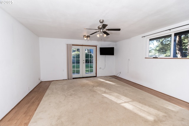 empty room featuring ceiling fan, french doors, and hardwood / wood-style floors