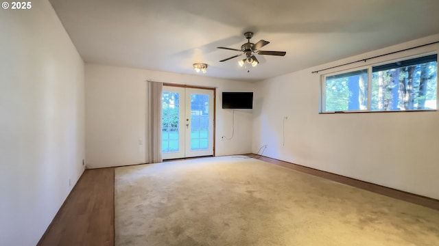 unfurnished room with ceiling fan, french doors, and hardwood / wood-style floors