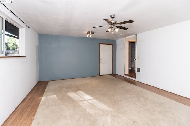 unfurnished room featuring ceiling fan and light hardwood / wood-style flooring