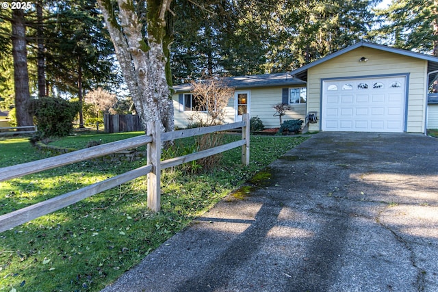 ranch-style house with a front lawn and a garage