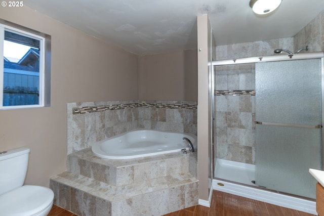 full bathroom featuring plus walk in shower, toilet, hardwood / wood-style flooring, and vanity