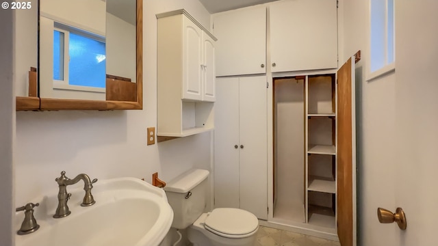 bathroom featuring toilet and sink