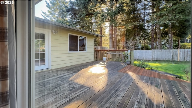 wooden deck with a lawn