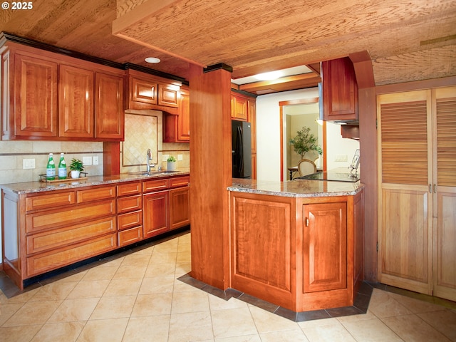 4214 NE Hassalo St, Portland, OR 97213 - kitchen featuring black fridge, wood ceiling, backsplash, stove, and light stone counters