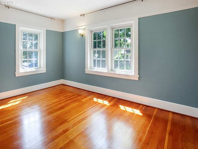 4214 NE Hassalo St, Portland, OR 97213 - empty room featuring plenty of natural light and hardwood / wood-style flooring