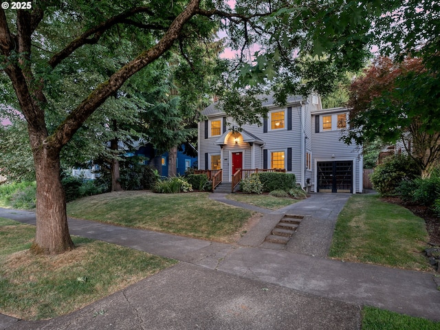 4214 NE Hassalo St, Portland, OR 97213 - view of front of home with an attached garage, driveway, and a yard