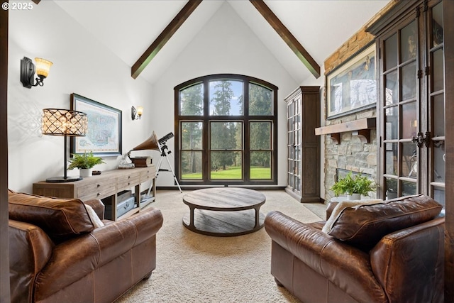 carpeted living room featuring high vaulted ceiling, beamed ceiling, and a fireplace