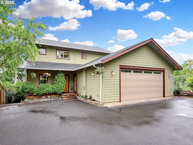 111 5th St, Silverton, OR 97381 - view of front of house with a shingled roof, driveway, covered porch, and an attached garage