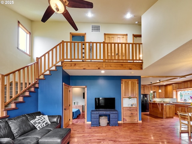 111 5th St, Silverton, OR 97381 - living room featuring a ceiling fan, healthy amount of natural light, light wood-style floors, recessed lighting, and a towering ceiling