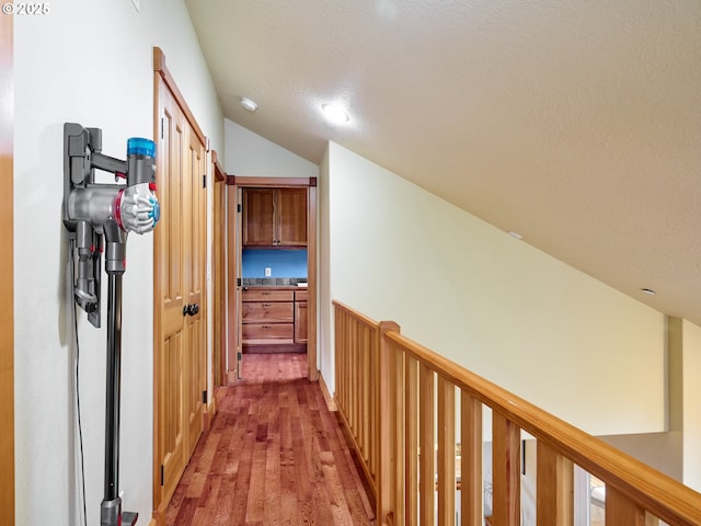 111 5th St, Silverton, OR 97381 - hall featuring light wood-style floors, a textured ceiling, and vaulted ceiling