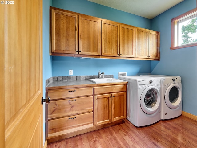 111 5th St, Silverton, OR 97381 - laundry room with cabinet space, light wood-type flooring, and separate washer and dryer