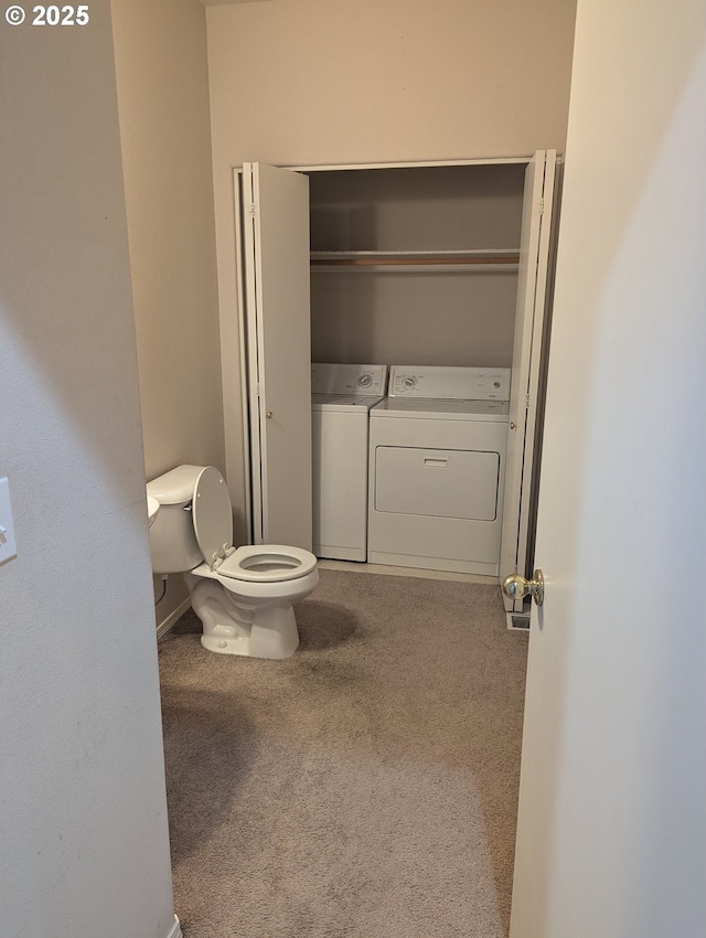 bathroom with independent washer and dryer