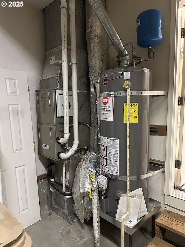 utility room featuring water heater