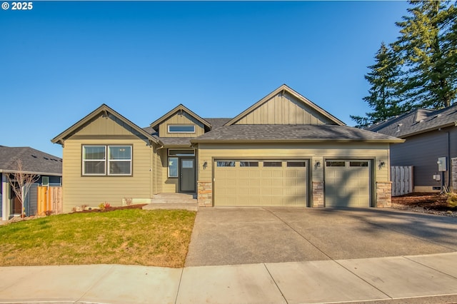 craftsman house featuring concrete driveway, stone siding, an attached garage, fence, and board and batten siding