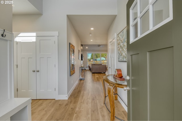 corridor with recessed lighting, baseboards, and light wood finished floors