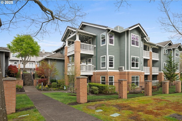 30326 SW Ruth St Unit 58, Wilsonville, OR 97070 - view of front of home with fence private yard, a balcony, and brick siding