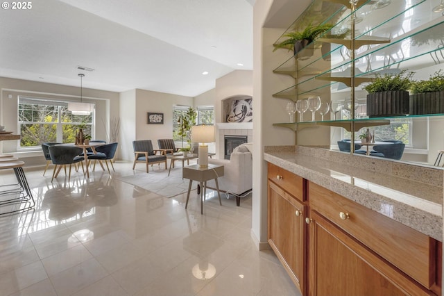30326 SW Ruth St Unit 58, Wilsonville, OR 97070 - bar with visible vents, vaulted ceiling, a wealth of natural light, and light tile patterned floors