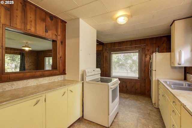 18570 Oakdale Rd, Dallas, OR 97338 - kitchen with white appliances, wooden walls, a sink, and light countertops