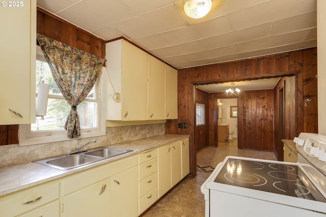 18570 Oakdale Rd, Dallas, OR 97338 - kitchen featuring white range with electric cooktop, a sink, wooden walls, a chandelier, and light countertops