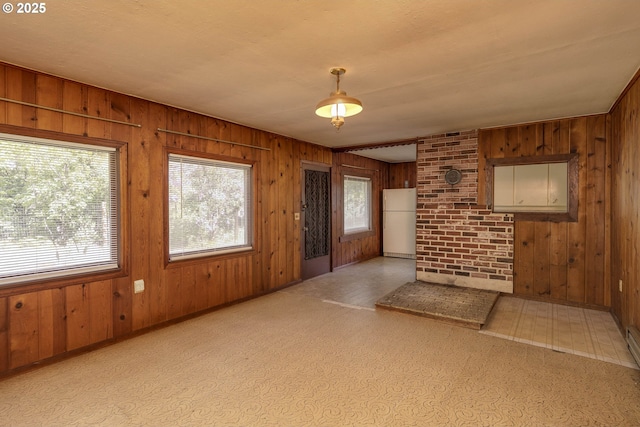 18570 Oakdale Rd, Dallas, OR 97338 - unfurnished living room with wood walls, plenty of natural light, and baseboards