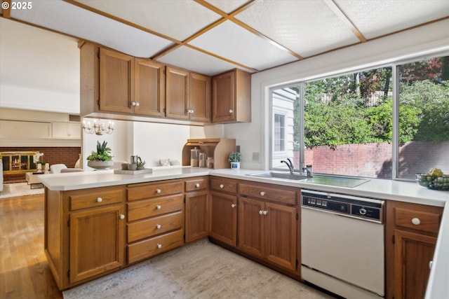 4401 SW Westdale Dr, Portland, OR 97221 - kitchen with a peninsula, light countertops, brown cabinetry, and white dishwasher