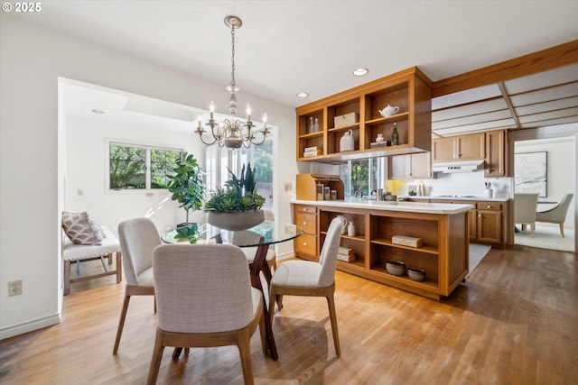 4401 SW Westdale Dr, Portland, OR 97221 - dining space with an inviting chandelier, light wood finished floors, a healthy amount of sunlight, and recessed lighting