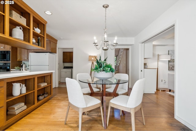 4401 SW Westdale Dr, Portland, OR 97221 - dining room with light wood-style flooring, a notable chandelier, baseboards, and recessed lighting