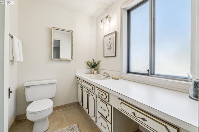 bathroom featuring toilet and vanity