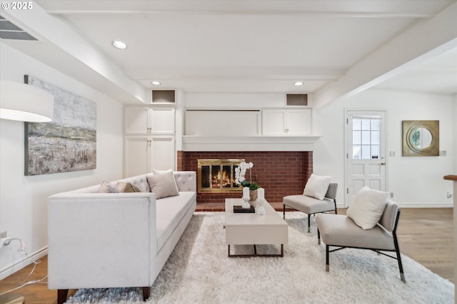 4401 SW Westdale Dr, Portland, OR 97221 - living room featuring recessed lighting, visible vents, wood finished floors, beamed ceiling, and a fireplace