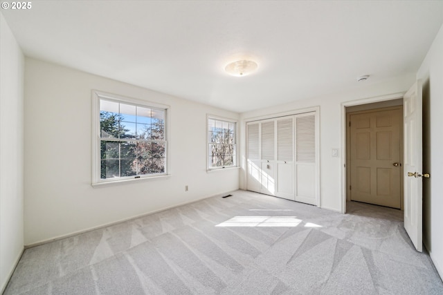 4401 SW Westdale Dr, Portland, OR 97221 - unfurnished bedroom featuring a closet, light carpet, and baseboards