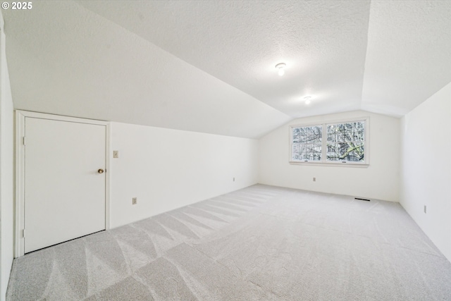 4401 SW Westdale Dr, Portland, OR 97221 - bonus room with lofted ceiling, a textured ceiling, visible vents, and carpet floors