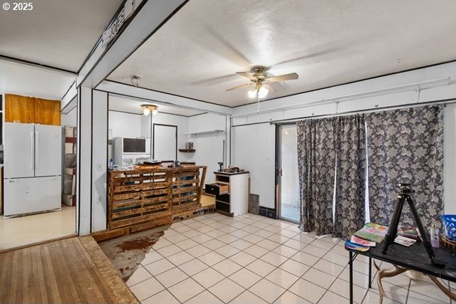 interior space featuring a ceiling fan and light tile patterned floors