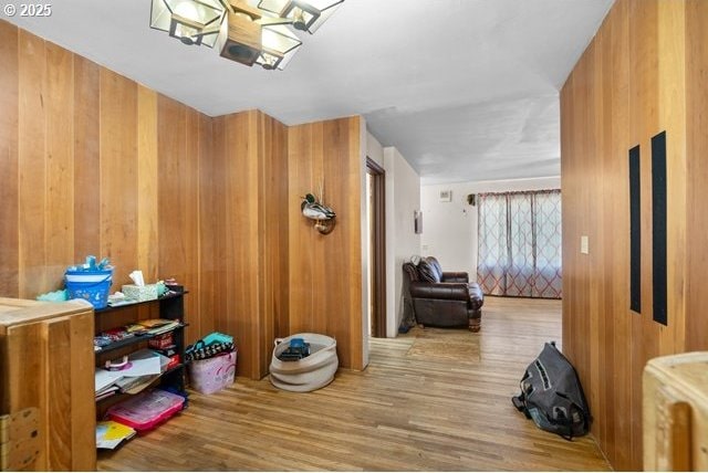 corridor featuring wooden walls and wood finished floors