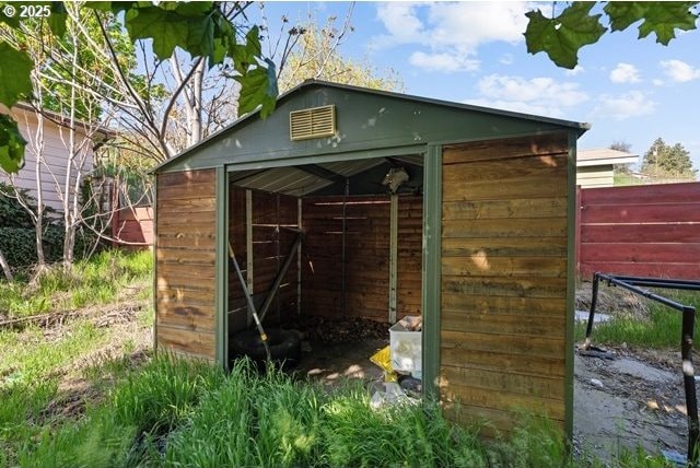view of outbuilding with an outbuilding and fence