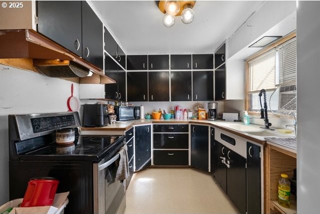 kitchen with a sink, open shelves, black appliances, light countertops, and dark cabinets