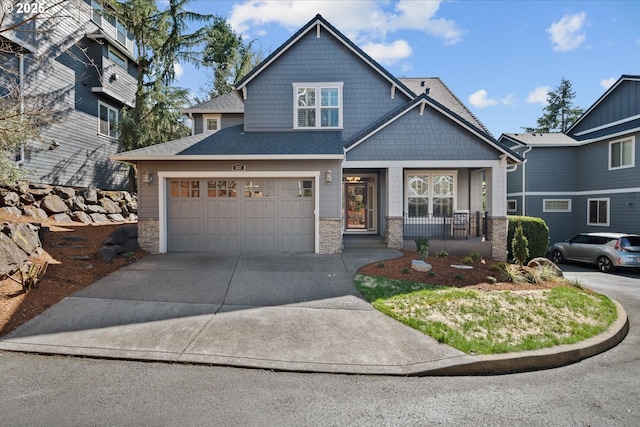 craftsman-style house with driveway, covered porch, stone siding, roof with shingles, and an attached garage