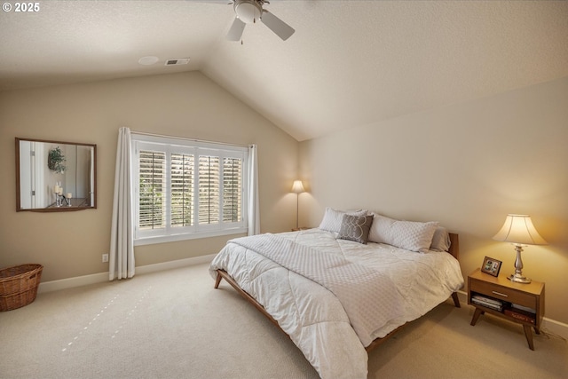 bedroom with light colored carpet, baseboards, vaulted ceiling, and visible vents