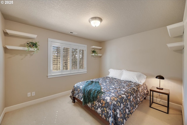 bedroom with carpet flooring, visible vents, baseboards, and a textured ceiling
